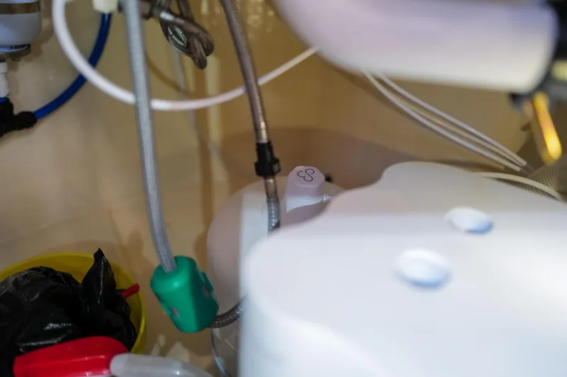 Slide: The Image of Under-sink plumbing with pipes and connections in a Leopard 43, 2006 model. - 106