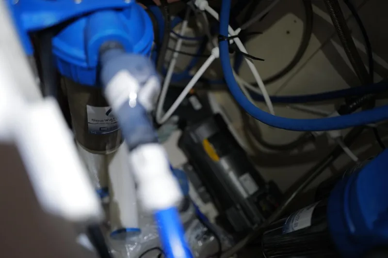Slide: The Image of Engine compartment of a 2006 Leopard 43, featuring blue hoses and mechanical components. - 107