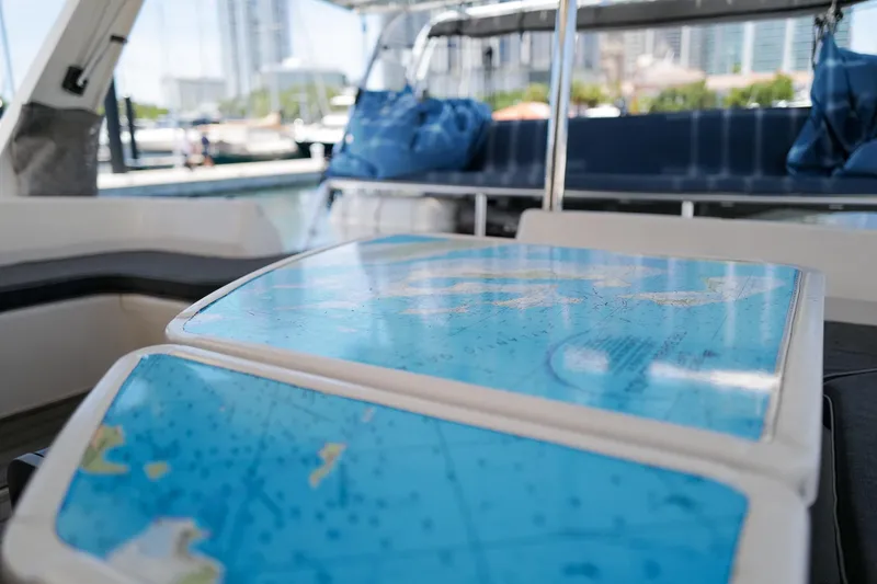 Slide: The Image of Interior of a 2006 Leopard 43 yacht featuring a nautical map table. - 14