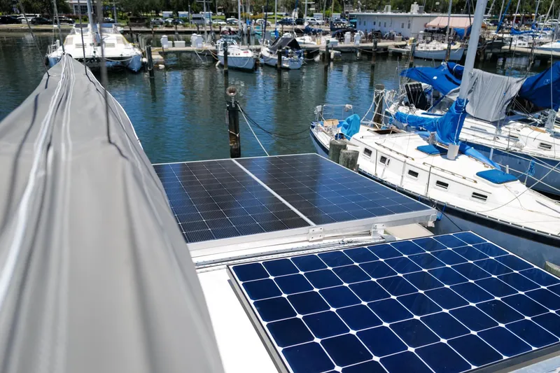 Slide: The Image of Solar panels on a 2006 Leopard 43 catamaran docked at a marina. - 15