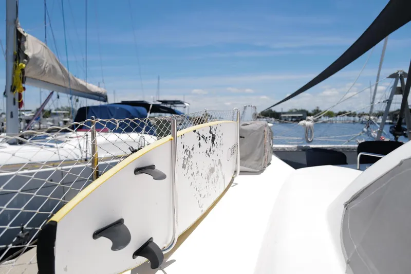 Slide: The Image of Sailboat deck with surfboard, Leopard 43 model, sunny marina view. - 16