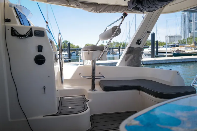 Slide: The Image of Interior view of a 2006 Leopard 43 yacht cockpit with seating and steering wheel. - 19
