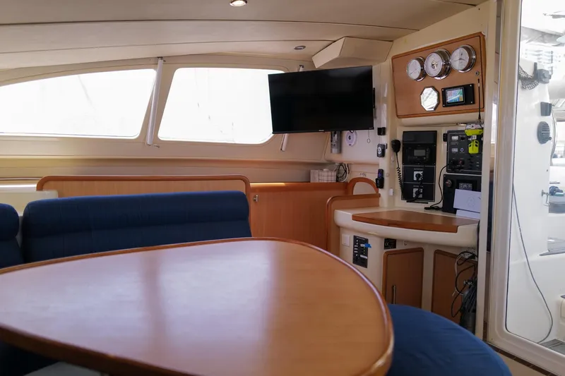 Slide: The Image of Interior of 2006 Leopard 43 yacht with modern navigation equipment and cozy seating area. - 25