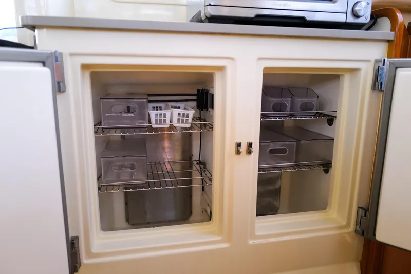 Slide: The Image of Open storage cabinet with organized containers on wire shelves, Leopard 43, 2006 model. - 33