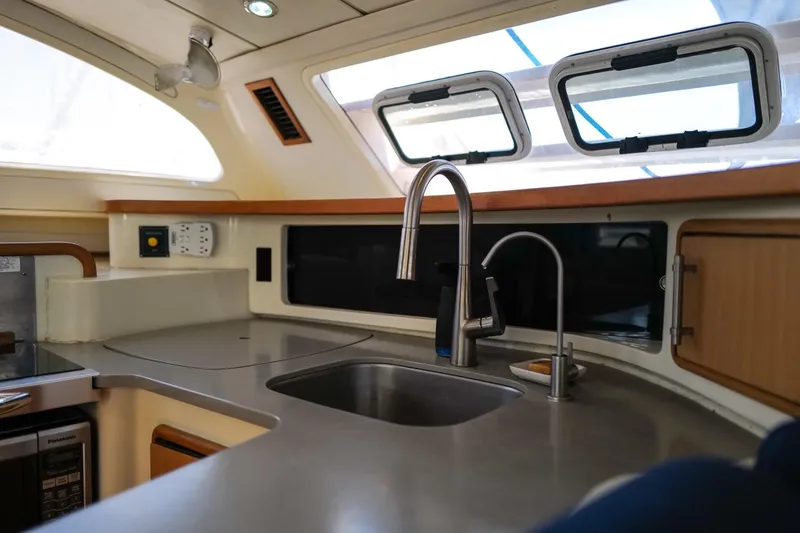 Slide: The Image of Modern kitchen interior of 2006 Leopard 43 yacht with stainless steel sink and appliances. - 36