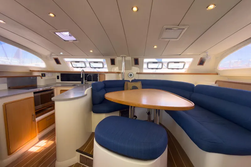 Slide: The Image of Luxurious interior of a 2006 Leopard 43 yacht with blue seating and modern kitchen amenities. - 38