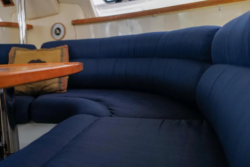 Slide: The Image of Interior of 2006 Leopard 43 yacht with blue cushioned seating and wooden table. - 41