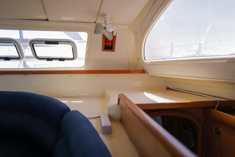 Slide: The Image of Interior of a 2006 Leopard 43 yacht with blue seating and large windows. - 43