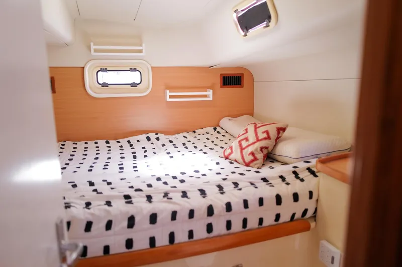 Slide: The Image of Cozy cabin interior of 2006 Leopard 43 yacht with patterned bedding and pillows. - 45