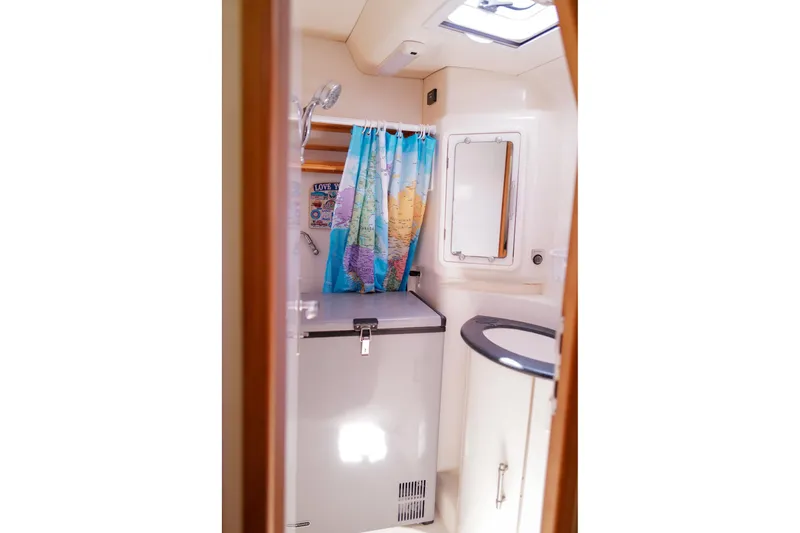 Slide: The Image of Bathroom interior of a 2006 Leopard 43 yacht with map-themed shower curtain. - 46