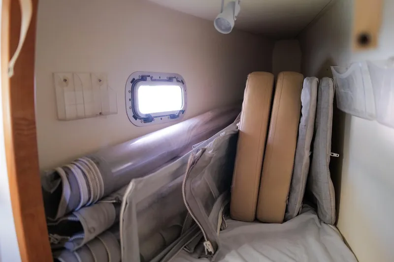 Slide: The Image of Storage area in a 2006 Leopard 43 yacht with cushions and rolled-up items. - 47