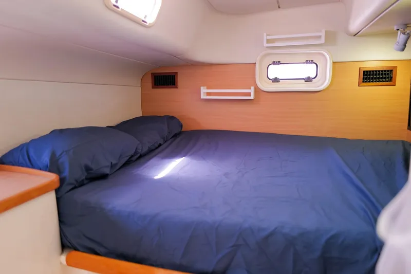 Slide: The Image of Cozy cabin interior of a 2006 Leopard 43 yacht with a comfortable bed. - 48