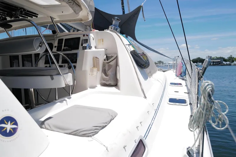 Slide: The Image of 2006 Leopard 43 catamaran deck with helm, docked on a sunny day. - 5