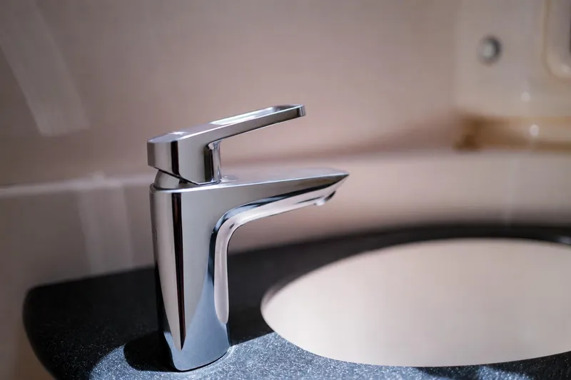 Slide: The Image of Chrome faucet on black countertop in Leopard 43, 2006 model yacht bathroom. - 56