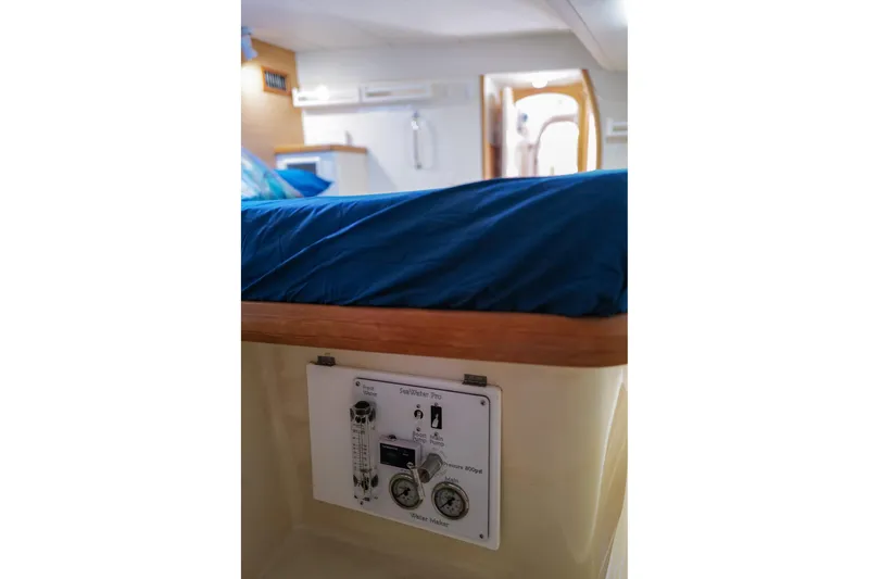 Slide: The Image of Interior of a 2006 Leopard 43 yacht showing a control panel under a bed. - 60