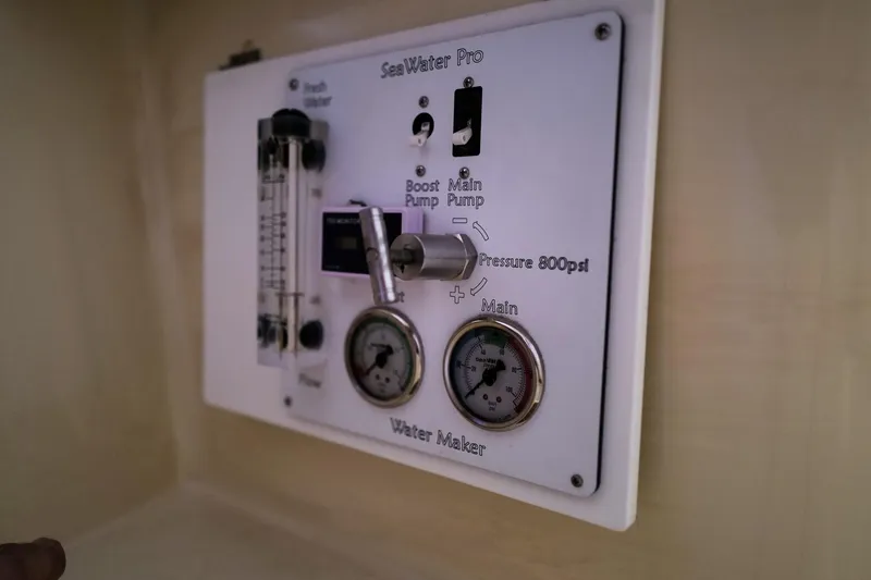 Slide: The Image of Control panel of a 2006 Leopard 43 water maker with pressure gauges and switches. - 61