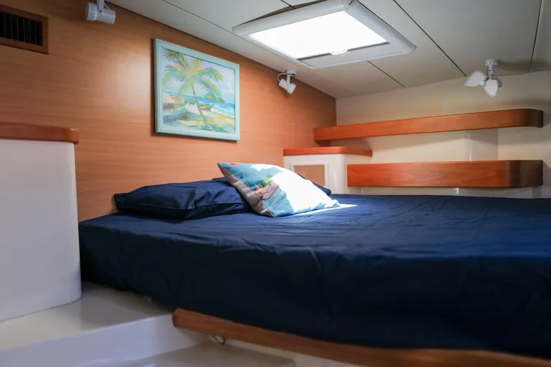 Slide: The Image of Cozy cabin interior of 2006 Leopard 43 yacht with bed and tropical artwork. - 63