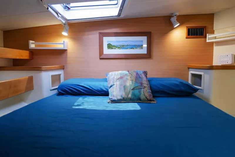 Slide: The Image of Cozy cabin interior of 2006 Leopard 43 yacht with blue bedding and wall art. - 65