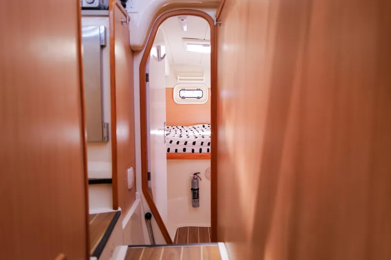 Slide: The Image of Interior of 2006 Leopard 43 yacht cabin with wooden finish and cozy bed. - 67