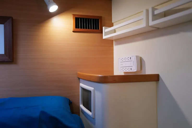 Slide: The Image of Interior cabin of 2006 Leopard 43 yacht with blue bedding and modern lighting. - 68
