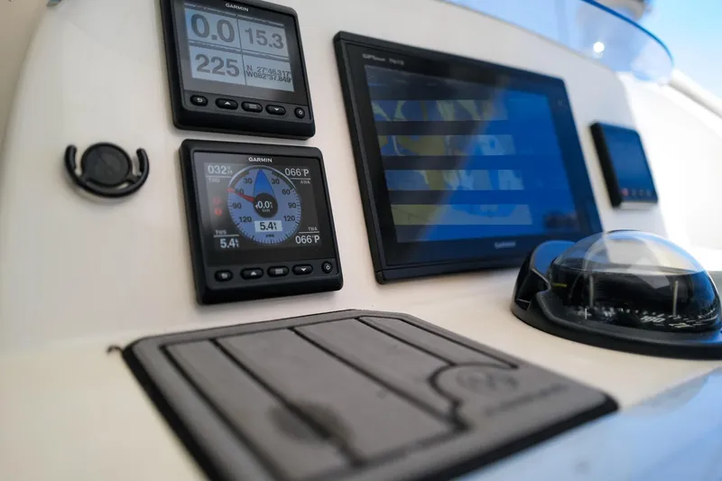 Slide: The Image of Navigation instruments on a 2006 Leopard 43 yacht, featuring Garmin displays and compass. - 7