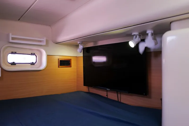Slide: The Image of Interior cabin of a 2006 Leopard 43 yacht with a mounted TV and spotlight. - 71