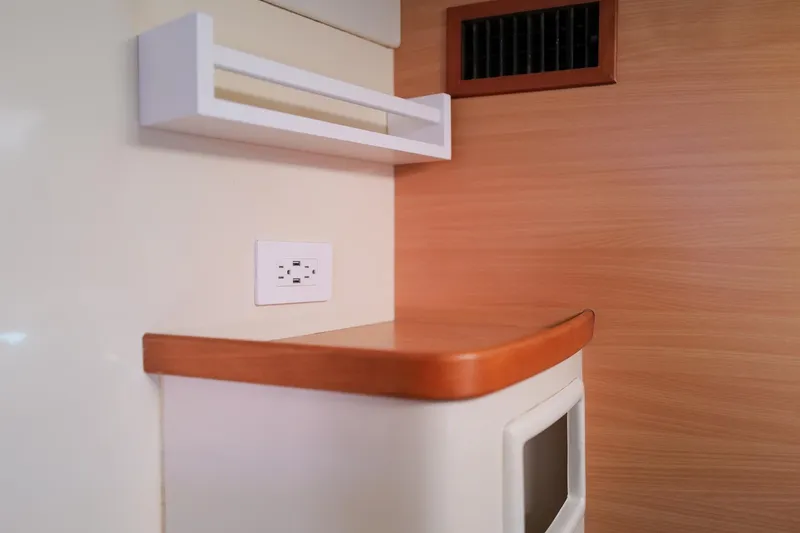 Slide: The Image of Interior of a 2006 Leopard 43 yacht with wood paneling and electrical outlet. - 72