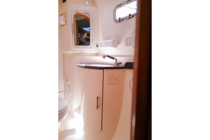 Slide: The Image of Bathroom interior of a 2006 Leopard 43 yacht, featuring a sink and mirror. - 74