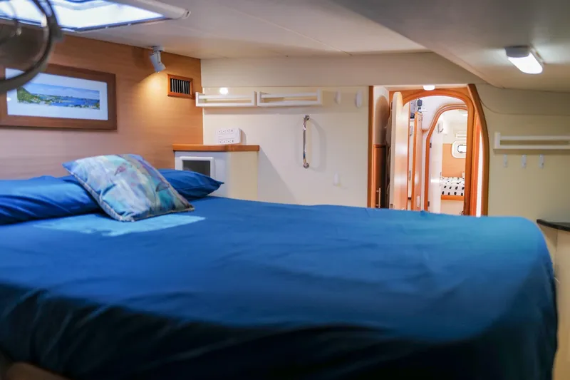 Slide: The Image of Luxurious cabin interior of a 2006 Leopard 43 yacht with blue bedding and modern decor. - 76