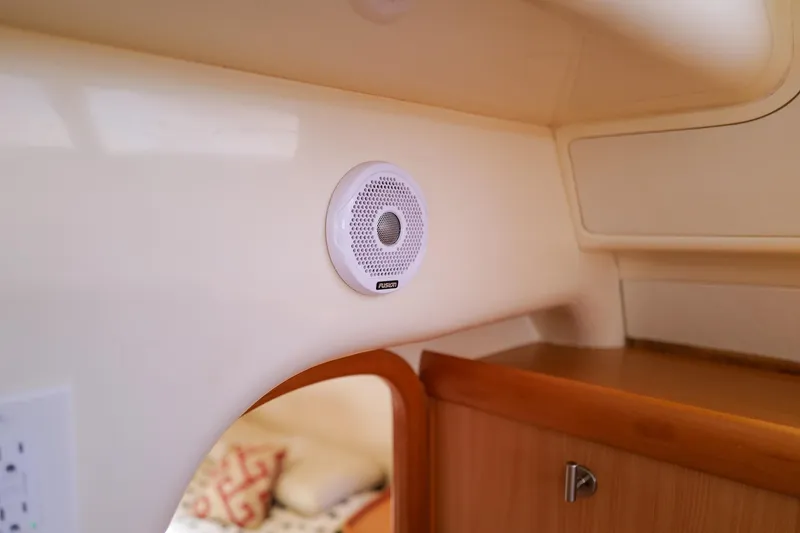 Slide: The Image of Interior of a 2006 Leopard 43 yacht featuring a Fusion speaker on a wooden cabinet. - 78