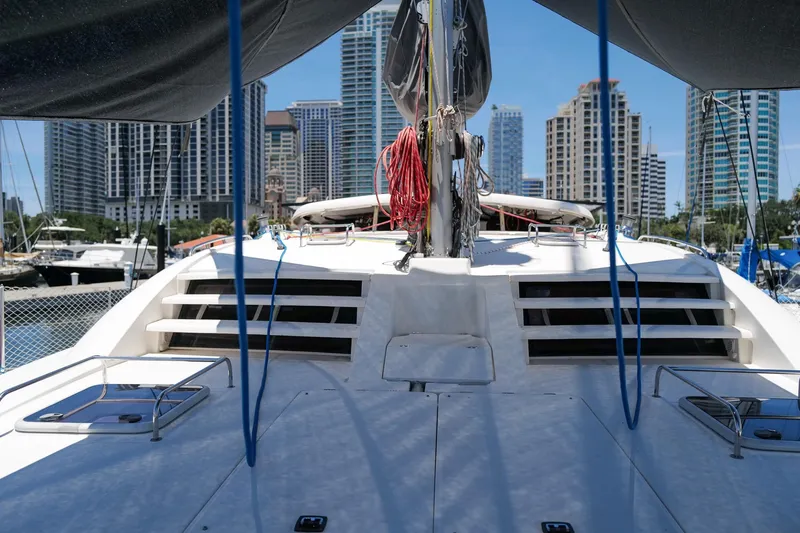 Slide: The Image of 2006 Leopard 43 catamaran docked in urban marina with city skyline backdrop. - 80