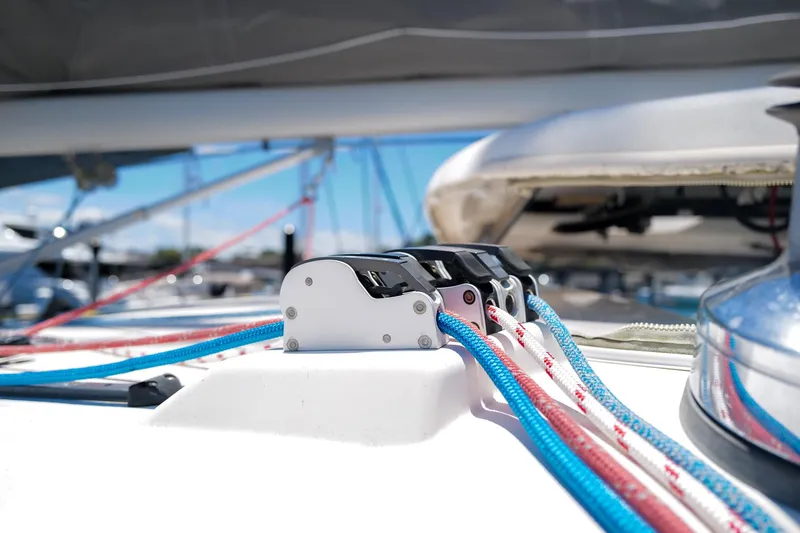 Slide: The Image of Close-up of sailing ropes and cleats on a 2006 Leopard 43 catamaran deck. - 84