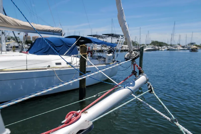 Slide: The Image of Sailboat rigging on a 2006 Leopard 43 in a marina, with clear blue skies. - 85