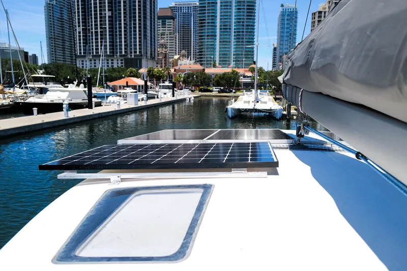 Slide: The Image of Leopard 43 catamaran with solar panels docked in a marina, city skyline in background. - 86
