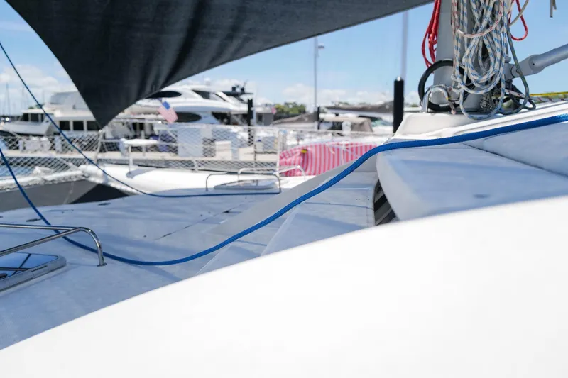 Slide: The Image of Sailboat deck view of 2006 Leopard 43, featuring ropes and marina background. - 92