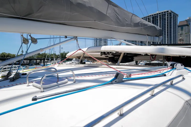 Slide: The Image of Deck view of a 2006 Leopard 43 catamaran with rigging and city skyline backdrop. - 97