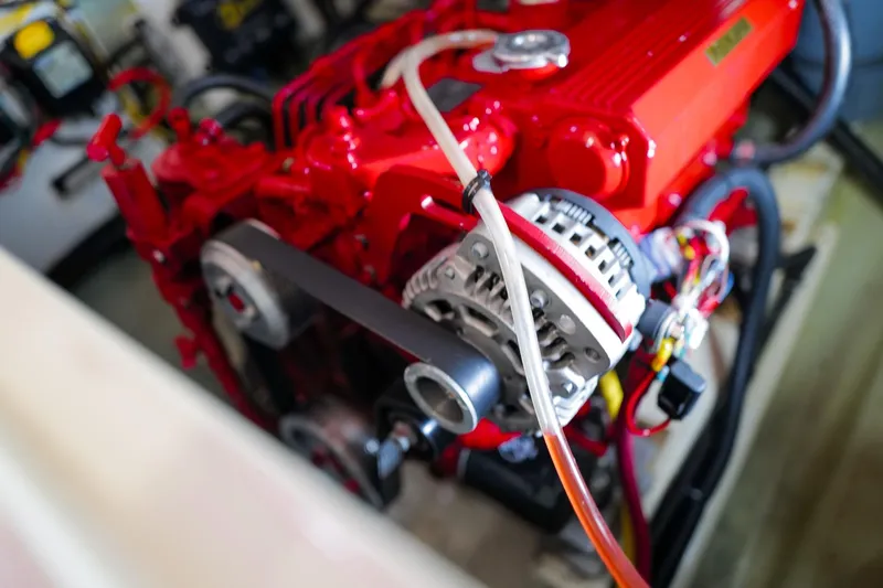 Slide: The Image of Red engine of a 2006 Leopard 43 yacht, showcasing detailed components and wiring. - 99
