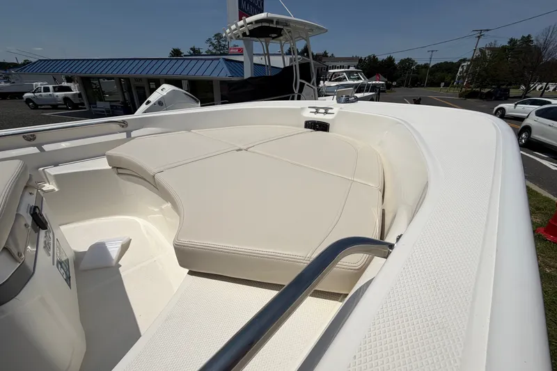 Slide: The Image of The image shows the bow area of a Boston Whaler 170 Montauk with beige cushions. - 3