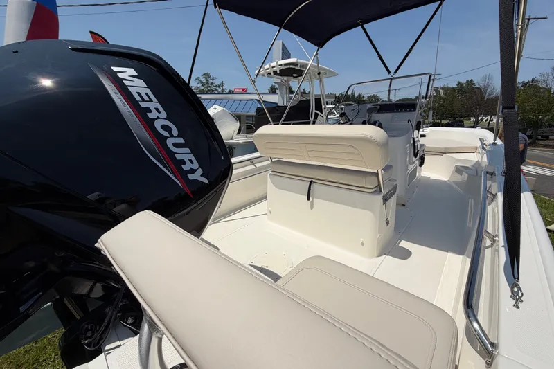 Slide: The Image of The image shows a Boston Whaler 170 Montauk boat with a Mercury outboard motor. - 12