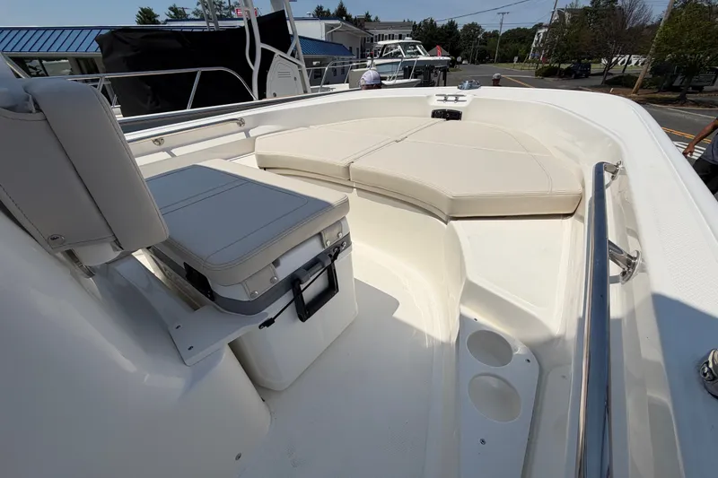 Slide: The Image of The image shows the bow area of a 2027 Boston Whaler 170 Montauk with white cushions. - 5