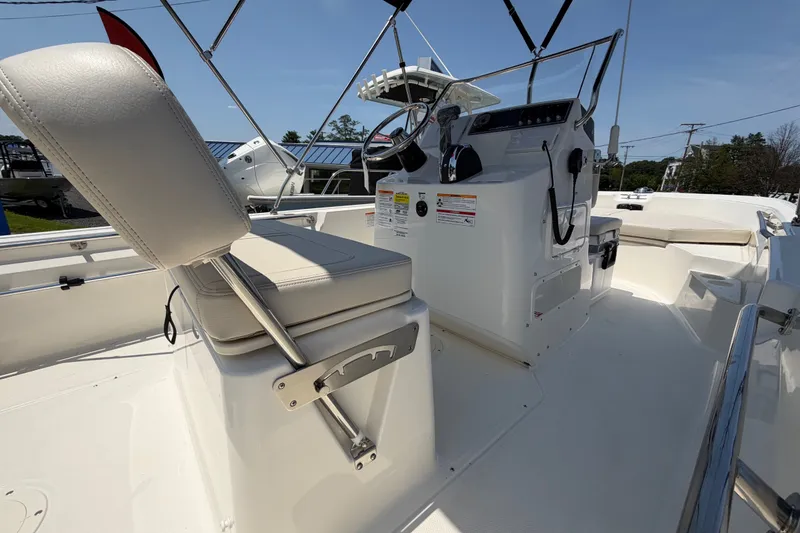 Slide: The Image of The image shows the cockpit of a 2027 Boston Whaler 170 Montauk with a helm and seating. - 10