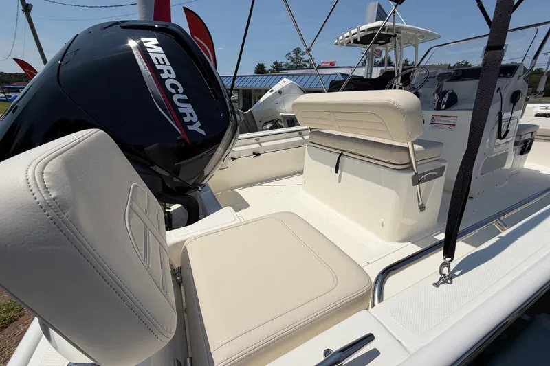 Slide: The Image of The image shows the cockpit of a Boston Whaler 170 Montauk with a Mercury outboard motor. - 11