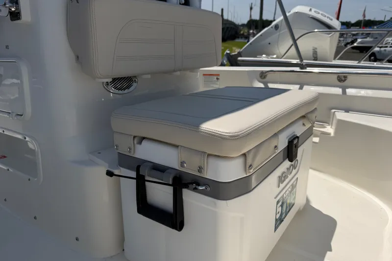Slide: The Image of The image shows a bench seat with an integrated cooler on a Boston Whaler 170 Montauk boat. - 4