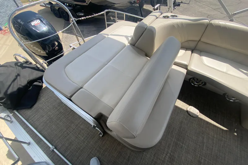 Slide: The Image of 2018 Harris Solstice 240 boat interior with beige seating and Mercury 250 engine. - 23