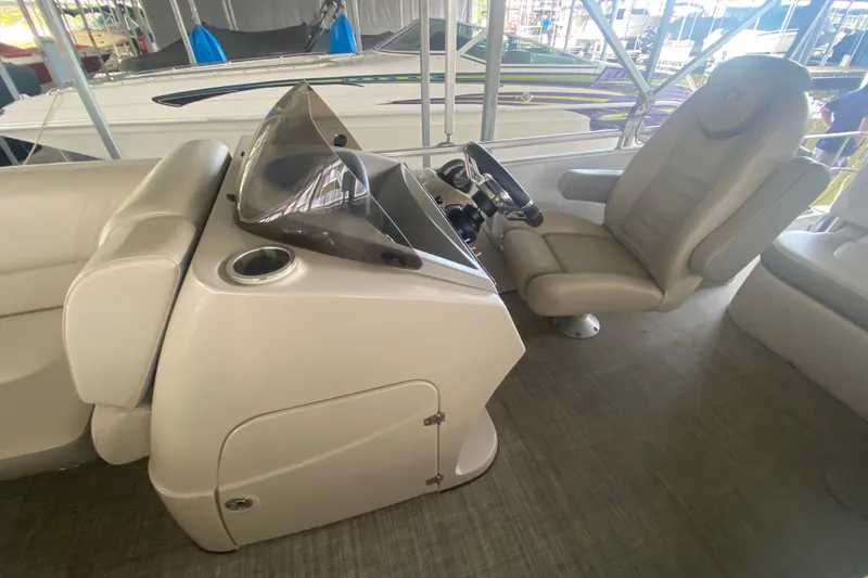 Slide: The Image of Captain's seat and console of a 2018 Harris Solstice 240 boat. - 13