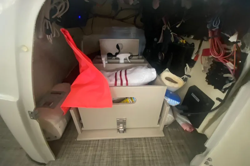 Slide: The Image of Interior storage compartment of a 2018 Harris Solstice 240 boat, featuring organized equipment. - 14
