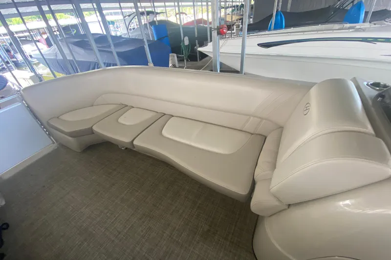 Slide: The Image of 2018 Harris Solstice 240 boat interior with beige seating and carpeted floor. - 15