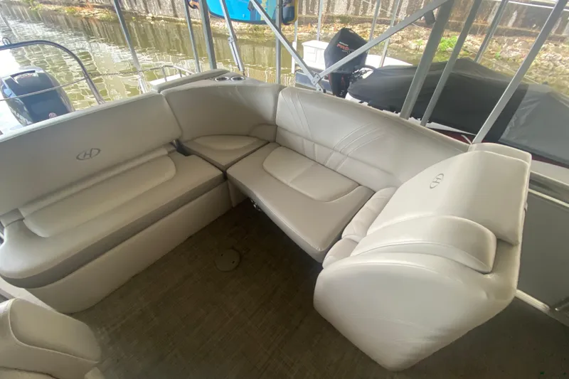 Slide: The Image of 2018 Harris Solstice 240 boat interior with plush seating and scenic water view. - 22