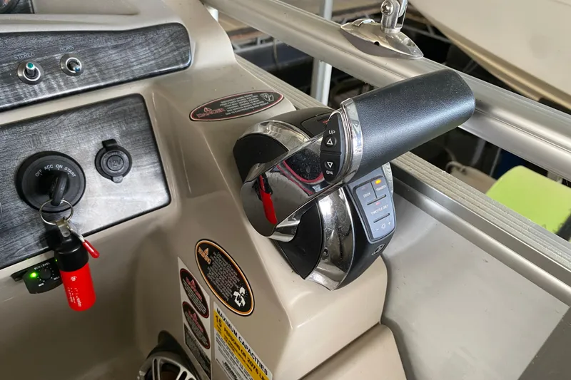 Slide: The Image of Control panel of a 2018 Harris Solstice 240 boat with throttle and ignition. - 23