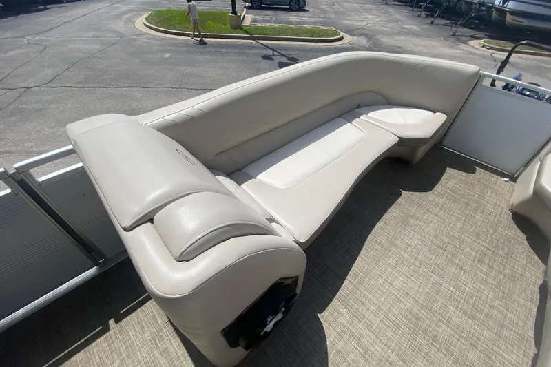 Slide: The Image of 2018 Harris Solstice 240 boat interior with beige seating and carpeted flooring. - 9